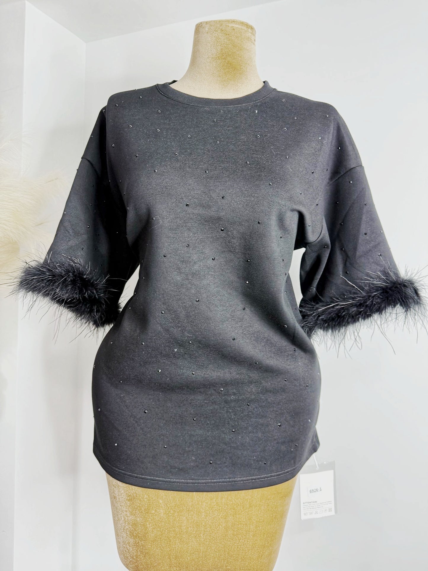 Chic Black sweater dress featuring luxurious fur cuffs